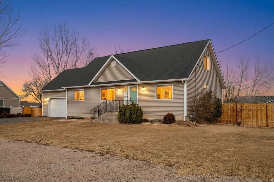 Spacious 6-bedroom home on a gorgeous half acre lot. Two master bedroom suites, one on main level & the second upstairs with its own sitting area & loft. Downstairs is a second family room w/kitchenette, a wood stove, additional bedrooms, a large bathroom w/walk-in shower & heated tile floors; a large storage room w/built in shelving. The backyard is an entertaining dream with deck, sheds, firepit, extra concrete slab, several raised beds, tall mature trees around the perimeter for shade & privacy. The home has a new roof, some new fencing, a gate into the back off 2700 W for access and RV/trailer parking. There is also RV parking place in front. If your family needs space and a beautiful enclosed yard, you can't beat this wonderful home, only minutes from downtown, shops & recreation!