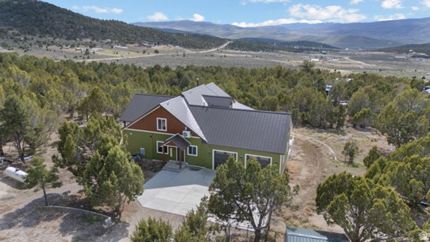 Stunning Hideaway Valley estate on Storm Mountain Rd! This custom home features a main-floor master, vaulted ceilings, and a $26k sound system. The gourmet kitchen boasts charcoal stainless appliances, granite counters, and 10' ceilings. Includes a walkout basement with a full apartment, gym, and secret safety room (pp. 1, 3). The 3,200 sq ft top floor offers a bar and rec area. Outside, enjoy a detached cabin with its own bathroom, 40' shop, barn, chicken coop, and 4 shipping containers on a gravity-fed well system. Incredible views and custom finishes throughout!  Have your agent print off the Property Information Sheet attached to the listing for more detailed information on this amazing property.