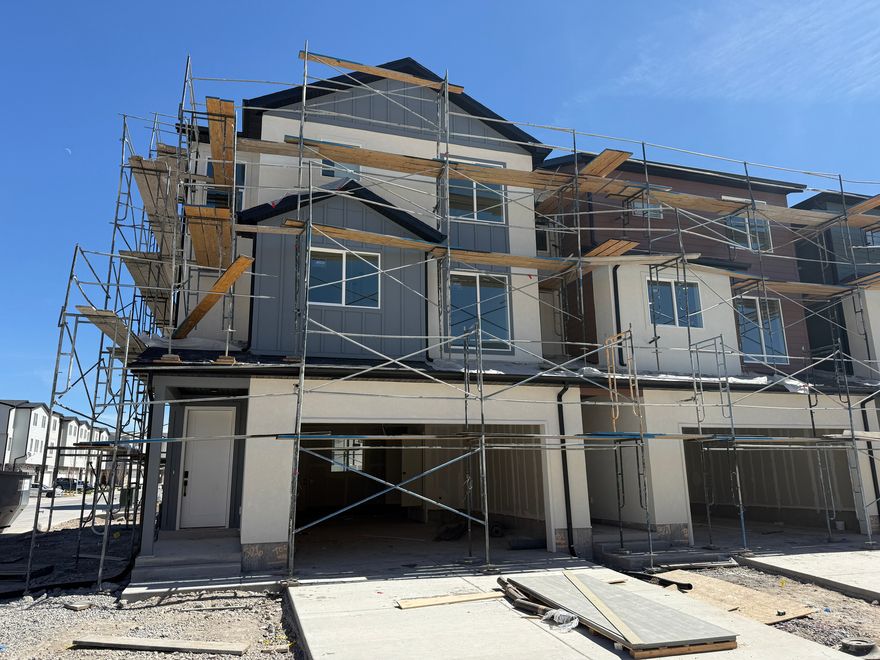 End-unit - Elevated design. Close before end of April to receive additional builder incentives-timing matters. 3-story townhome built for real life. 3 bedrooms, 2.5 baths, deep 3-car garage with extended storage for bikes, gear, seasonal overflow. Smart separation of space across levels creates privacy where needed, openness where it counts. Main level: light-filled, open flow. 9' ceilings, 8' doors, oversized windows amplify volume. Clean, modern finish throughout-waterproof LVP flooring, matte black hardware, contemporary trim. Kitchen dialed in for function and durability. Quartz counters. 42" custom cabinetry with soft-close dovetail drawers, pull-out shelving, dedicated garbage cabinet, cookie-sheet storage. 16-gauge single-bowl stainless sink, Moen Sleek faucet, GX Pro disposal with air-switch. LG microwave and range. Upstairs: all 3 bedrooms. Primary suite with dual closets, private bath. Bathrooms finished with quartz, adult-height vanities, framed mirrors, premium Moen fixtures. Primary bath includes double vanity, water closet, semi-Euro glass shower with built-in shelving and footrest. Efficiency + tech built in: 95% Lennox furnace, 14-SEER A/C, Honeywell T9 Wi-Fi thermostat, EV charging rough-in, Kwikset Z-Wave lock, LiftMaster MyQ garage system, Cat-6 wiring, charging outlets (including pantry). Amsco Studio windows. Stucco exterior with James Hardie accents. End unit. More light. More privacy. More value.  Square footage figures are provided as a courtesy estimate only and were obtained from builder plans.  Buyer is advised to obtain an independent measurement.