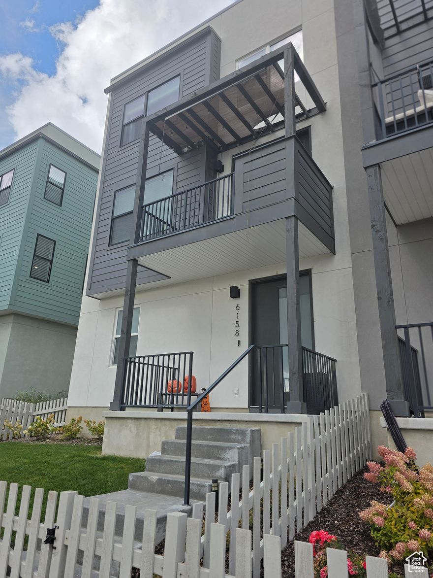 Modern Townhome Built in 2022  Prime Daybreak Location - Seller Financing Available. This stylish 3-bedroom townhome offers modern design, thoughtful details, and a fantastic location. Built in 2022, it features a fenced front patio, spacious 2-car garage with extra storage, and an outlet for an electric car charger. Inside, you'll find 9-foot ceilings, oversized picture windows, quartz countertops, a tile backsplash, laminate flooring, pendant lighting, and LED disc lighting. The second-floor patio provides beautiful views of the mountains, while the tankless water heater and smart home features-keyless entry, video doorbell, smart thermostat, and smart garage door opener-add comfort and convenience. Located in the vibrant Daybreak community, you'll enjoy access to a pool, parks, scenic walking trails, and expanding commercial developments. Just minutes from downtown Daybreak and the Salt Lake Bees' new ballpark, this home blends modern living with exciting amenities and entertainment options.