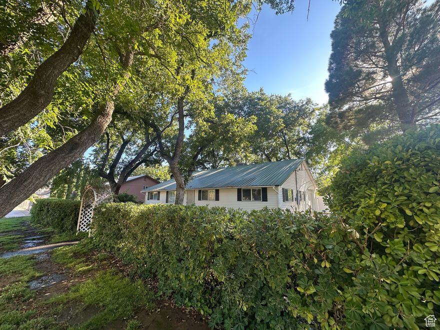 Location! Location! Location! Historic Toquerville, Utah serves as the northern gateway to picturesque Zion National Park. Being 30 miles South of Cedar City and 20 miles North of St. George, you are surrounded by all modern amenities while living in a spectacular natural setting! Get out of the rat race and be a short drive from beautiful red rocks, amazing hiking, biking, canyoneering, backpacking, ATV riding, swimming and a multitude of outdoor activities!   This newly renovated three-bedroom, two-bathroom, open concept rambler is nestled in the heart of Toquerville, Utah. If privacy appeals to you, you'll find it here! This home boasts a private, fully fenced corner lot surrounded by mature trees, featuring a covered patio making it great for entertaining! The gorgeous, large shade trees (including pecan, cherry, plum apricot and almond) attract many beautiful migratory birds and provide a perfect escape/retreat after a long day of work or adventure.   Pride of ownership is evident with this home. Many recent renovations have been completed and there are too many to list. A few notable renovations include a brand-new ECO BEE HVAC system, new LVP and Tile flooring throughout, new paint and total bathroom renovations including the primary en suite with luxury shower and free-standing soak tub makes you feel like you're at a luxury spa! The HUGE detached garage is perfect for an auto body or wood-working shop and is large enough to store everything you need for recreation and outdoor adventures! The garage is equipped with 220 voltage outlets and two 10' garage bay doors. For convenience, the garage also features its own private bathroom, electrical panel and swamp cooler. The RV pad adds extra space for all your toys! SO many options with this garage! Dream Big! The smaller shed in the backyard is also equipped with its own water, drain, air-conditioning and electrical panel which makes it perfect for additional storage, living and/or project space. Hello man cave or she-shed!!   Income producing potential exists with this home! Given its proximity to the National Park and all other recreational areas, short term, nightly rental options may exist. Airbnb requests must be approved by the city. Whether it's your dream property or an investment opportunity, you'll absolutely love this home and all it has to offer! Please note, square footage figures are provided as a courtesy estimate only and were obtained from past appraisal records. Buyer is advised to obtain an independent measurement. Buyer to verify ALL information.