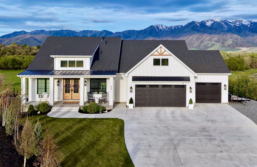Unlike anything else in the area, this custom-built home offers breathtaking 360 views of the Wellsville Mountains and valley. Situated on over an acre, enjoy a private setting with a grand driveway, abundant parking, and beautifully landscaped grounds. Built with Parade of Homes quality, the home features a bright open layout, coffered-ceiling great room, and an oversized chef?s kitchen with double ovens, ample cabinetry, and a crushed ice machine. Spacious bedrooms offer flexibility for family or office use, while the private primary suite includes a spa-like bath and convenient laundry access. The fully finished basement includes a theater room, half kitchen, and extra storage. Step outside to a large backyard with mature trees, gas fire pit, and expansive patio?perfect for taking in the incredible views. Oversized 3-car garage with deep third bay. Prime location near parks, schools, shopping, and minutes from Logan. Immaculate and shows like new. Showings will begin on Saturday April, 25.