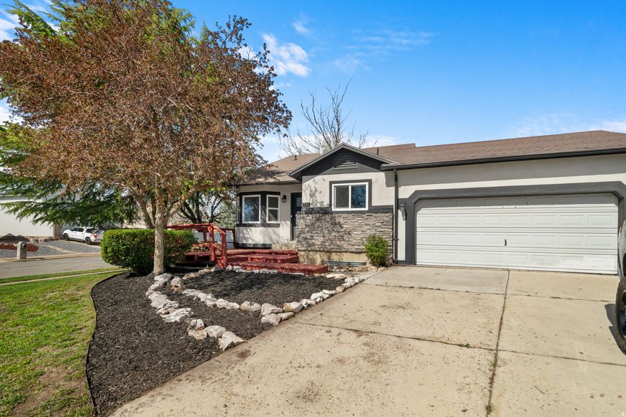 Darling tri-level on a large south facing corner lot in a cul-de-sac, located close to schools and parks. You'll catch beautiful mountain views from the front porch. Inside, the main level has vaulted ceilings that give the space an open feel. The family room is warm and inviting with built-in shelving and a gas fireplace. The basement is fully finished and includes a large bedroom. Brand new carpet throughout the home. The 2-car attached garage opens to the backyard patio for easy access. The yard is fully fenced and includes mature trees, including cherry and peach trees, plus a raised garden bed. There's also a detached shed for storage or a small workshop.