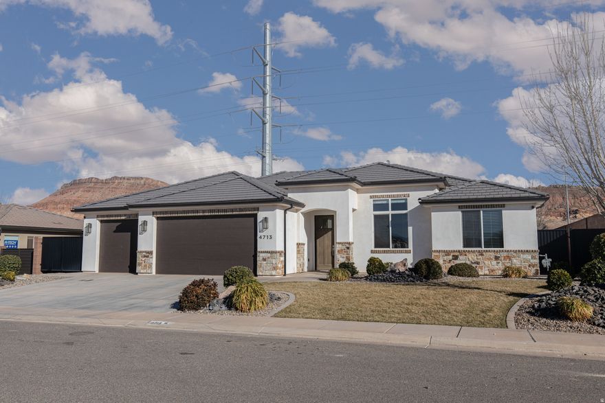 Beautiful home in the attractiveWarnerGatewayneighborhood in sunny Southern Utah! Great curb appeal, with an even better-looking interior. Fresh paint, new carpet/pad & other touch up work make this home feel brand new. Home is loaded with high-quality finishes, tile floors, 3-tone paint & oversized picture windows. Chef's kitchen with custom cabinetry, quartz countertops & GE caf appliance package! Spacious primary bedroom & bathroom, beautiful tile work, a large shower, garden tub & deep walk-in closet. Manicured landscaping with mature plants.