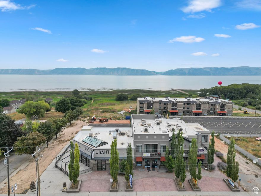 Incredible opportunity to own a gorgeous mixed use in the heart of Bear Lake! This is located walking distance to the shore. It includes 1 3500 sq foot restaurant space to serve the busy crowds and 3 retail store fronts, with 2 office/retail spots on the back of the building. 3 luxury condos on the top floor to make a total of 7 units! Call or text to set up a private tour you wont want to miss this!  Price includes an additional .25 acre building lot parcel#41-21-400-0062.