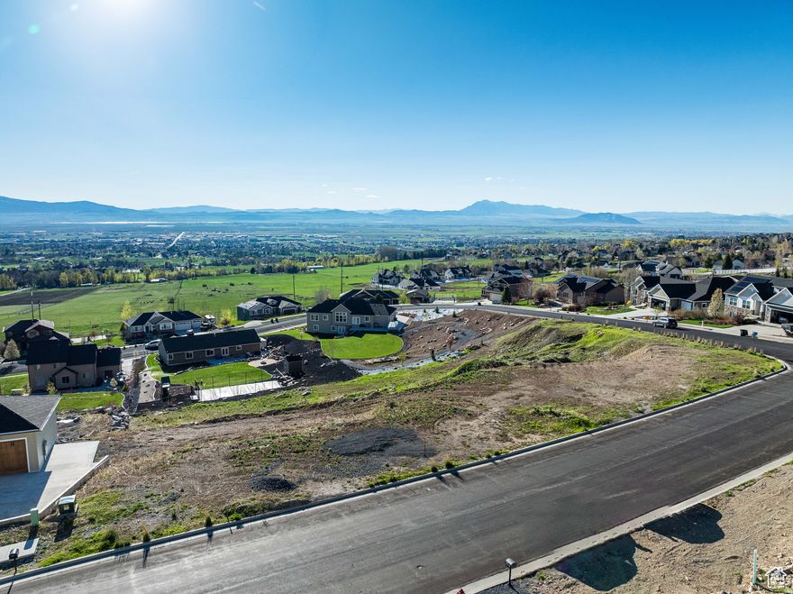 Set on North Logan's sought-after east bench, this homesite captures sweeping views of the valley, surrounding mountains, and USU's iconic Old Main. Opportunities to build in this quiet, established neighborhood are becoming increasingly limited-making this lot a rare find. Enjoy direct access to the Bonneville Shoreline Trail, stretching from Hyde Park to Hyrum, perfect for hiking, biking, and taking in the scenery. Utilities are already stubbed to the property. North Logan City requires geotech studies to build on this lot!