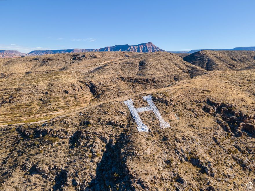 What the H!?!? You can own "The H!" Yes, the H on top of Hurricane Hill that's been saluting residents and visitors every time they enter the beautiful Hurricane Valley for many decades. Yes, the same H that Coach Wes made generations of HHS football players run wind-sprints up in the August sunshine, the same H that gets lit on fire for Homecoming, the same H atop the hill that legend has it Hurricane obtained it's name. This 80+ acre parcel offers many options: family legacy that one could keep and workout a lease to Hurricane City, 100 locals could join forces and each contribute $8,000 to own it together and preserve its History, adjacent property owners could buy to help them obtain their entitlement densities, potentially build a park with a class reunion center, and many more options. Don't miss this once in a lifetime opportunity to be a part of Hurricane history.  *Property lines on images are for illustration purposes only, buyer to verify parcel boundaries, zoning, access, utility locations, etc. to their own satisfaction prior to closing. All information is deemed reliable but not guaranteed, buyer to verify all.