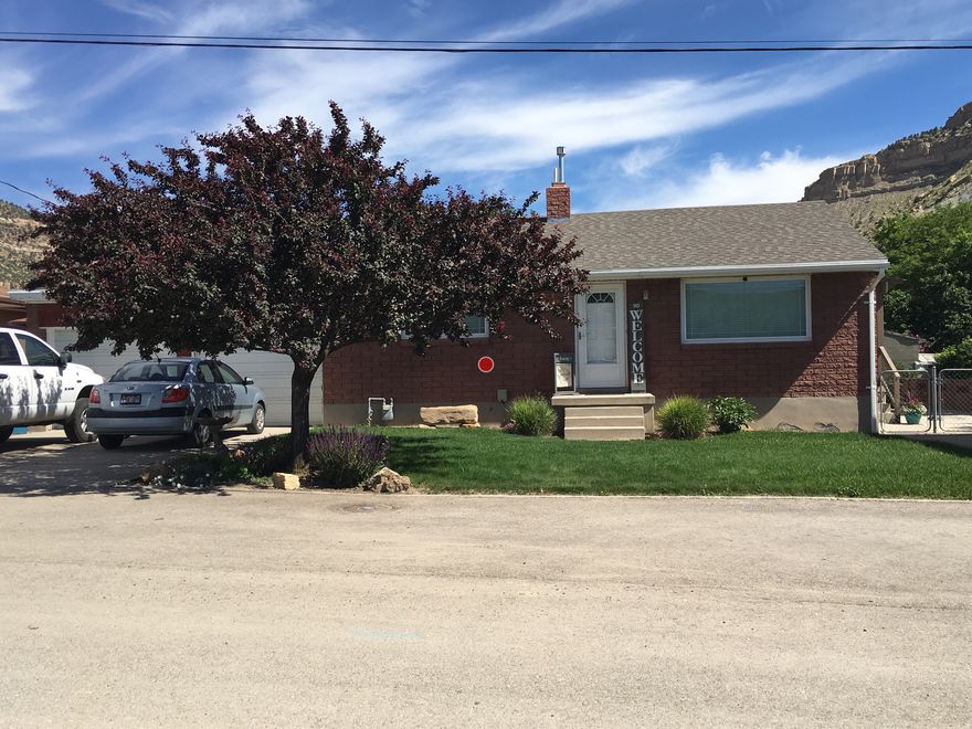 Imagine yourself in this charming, classic brick home, perfectly situated to capture the breathtaking beauty of the surrounding mountains. Step onto the property and immediately appreciate the spectacular, unobstructed views-a perfect backdrop for your morning coffee or evening relaxation. This home has been thoughtfully updated to enhance both comfort and peace of mind. The roof is just 1 year old, and the plumbing has been upgraded to modern PEX, offering reliability for years to come. Both bathrooms have been completely remodeled, featuring updated flooring and fresh paint. The kitchen shines with newer appliances, all approximately 1 year old, making meal preparation both stylish and convenient. Experience the ideal blend of tranquility and accessibility. Its location provides easy access to Helper's historic Main Street, placing local shops, art galleries, and dining just minutes away. Practicality meets comfort with an attached two-car garage, offering secure parking and additional storage. This home is a rare opportunity to enjoy the rugged beauty of the Helper area paired with the ease and convenience of town living.  Square footage figures are provided as a courtesy estimate only and were obtained from Carbon County .  Buyer is advised to obtain an independent measurement.