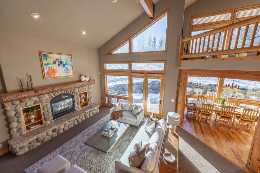 Set on half an acre and surrounded by mature trees and natural foliage, 2603 Aspen Springs Drive offers a rare blend of privacy and an in-demand central Park City location.   Designed for family living and ski-home entertaining, this five-bedroom, six-bath mountain retreat offers approximately 6,000 square feet of thoughtfully designed living spaces. Vaulted ceilings, abundant natural light, and an open floorplan define the great room, centered around a stacked stone gas fireplace and expansive windows that bring the surrounding mountain landscape indoors - the best place to enjoy quiet mornings or evening gatherings bustling with all the family.  Seamless flow between the living room, kitchen, and dining spaces, along with one bedroom comprise the main-level living. Upstairs, three bedrooms are complemented by a flexible office or reading nook, creating a functional layout well suited for families, remote work, or multigenerational living.  Outdoor living is easily accessed from the main living areas, with a wraparound stone patio and fully fenced backyard perfect for outdoor dining and year-round enjoyment.   Additional highlights include an oversized three-car garage with ski tuning room and a private lower-level mother-in-law apartment, offering flexibility for extended family or guests.  Tucked behind the iconic McPolin Barn, and just minutes from the base of Deer Valley Resort, Park City Mountain, Canyons, Old Town, golf, trails, and cross-country skiing - this home balances comfort, functionality, and thoughtful craftsmanship with rare in-town privacy, space, and immediate access to Park City's four-season lifestyle.