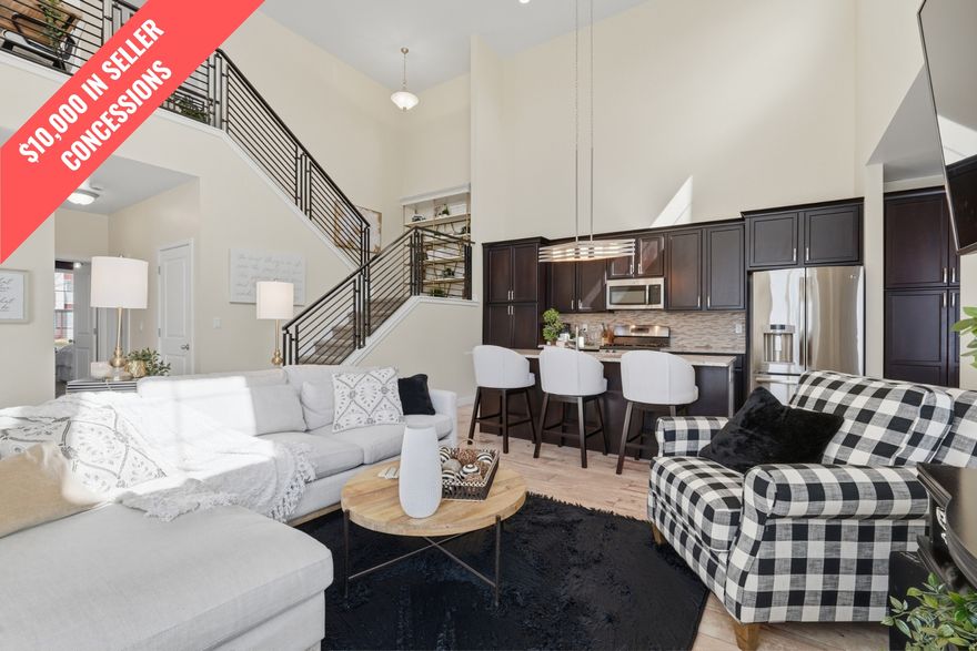 Experience light-filled, low-maintenance living in the heart of Daybreak-now offering $10,000 in buyer concessions!  This rare main-level primary suite townhome in Daybreak's North Shore offers one of the community's most desirable and functional floor plans-perfect for comfortable everyday living and effortless entertaining.  With approximately 2,788 square feet, this 4-bedroom, 4-bathroom home features open-concept living and a highly functional layout. The main-level primary suite includes a double vanity ensuite, walk-in shower, separate toilet room, walk-in closet, and convenient laundry hookups.  The vaulted two-story great room is filled with natural light from expansive windows and flows seamlessly into the modern kitchen and airy loft above. The kitchen includes granite countertops, a center island, gas range, stainless steel appliances, and contemporary finishes, while the loft offers flexible space for an office, lounge, or additional living area.  The fully finished basement expands your living space with a generous family room, additional bedrooms and bathrooms, and ample storage. Laundry hookups on multiple levels add convenience for everyday living.  Enjoy a covered patio, fully fenced yard, and HOA-maintained landscaping-ideal for lock-and-leave living. The extra-length two-car garage adds storage, and fiber optic internet is included through the HOA.  Located just moments from Oquirrh Lake, Harmons Grocery, and neighborhood parks and trails, this home also provides access to Daybreak's premier amenities, including pools, fitness centers, tennis and pickleball courts, and year-round community events.  Information provided as a courtesy only. Buyer and buyer's agent to verify all.