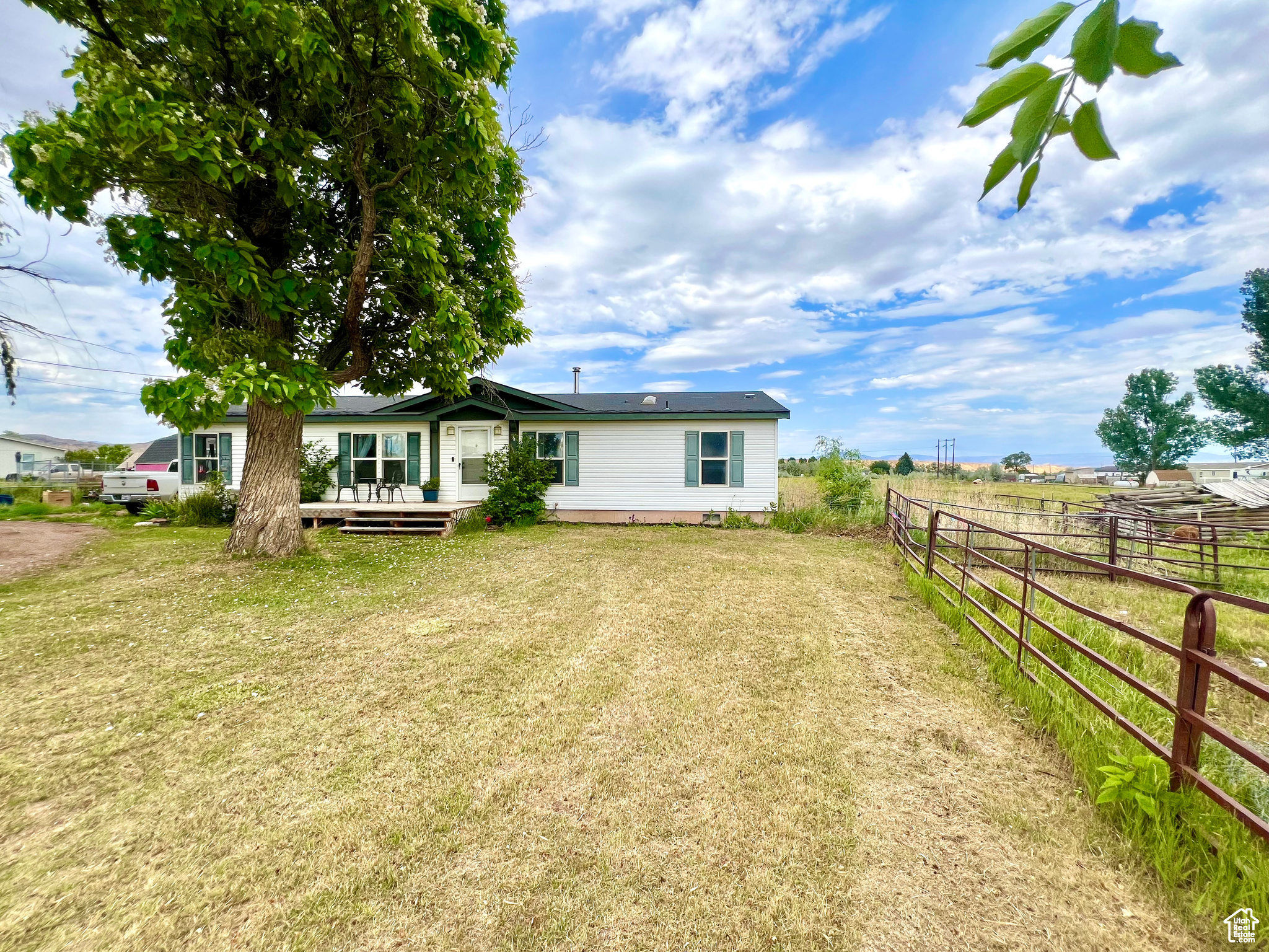 Charming home located on the outskirts of Vernal. Surrounded by beautiful farm lands - The views from the front, and back deck can't be beat - with large mature trees, lushes farm fields, and mountain landscapes in the distance. This darling home offers 2 living rooms, 3 bedrooms, 2 bathrooms, open concept with a large dining area, and ample space to entertain. Recently updated kitchen, and flooring in the main living areas. Outside offers beautiful mature trees, decks, goat pen, and raised garden beds.