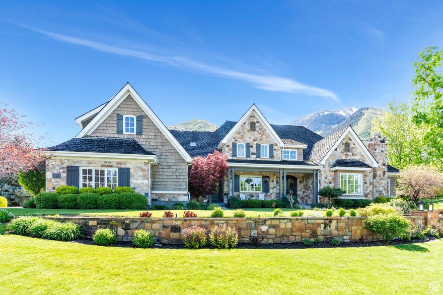 Sought after Eagle Rock retreat on Mapleton's East Bench. A stunning custom-built residence that perfectly blends timeless elegance with modern luxury. Nestled against the majestic backdrop of lush mountains, this 10,000 square foot stone and shingle-style masterpiece offers unparalleled curb appeal and a serene escape from the everyday.  As you approach the 1.58 acre property, you are greeted by meticulously landscaped grounds framed by a handcrafted stone retaining wall, showcasing vibrant greenery and seasonal blooms. The classic cedar shake siding, complemented by natural stone accents and charming window shutters, speaks to the home's artisan craftsmanship and thoughtful design.  Step through the grand front entrance into an inviting foyer bathed in natural light. Large windows throughout the home provide panoramic views of the mountains and surrounding landscapes, bringing the beauty of nature indoors. The main level boasts an expansive great room with vaulted ceilings, a stone fireplace, and custom millwork-ideal for both intimate gatherings and grand entertaining.  The gourmet kitchen is a chef's delight, featuring top-of-the-line stainless steel appliances, custom cabinetry, and a spacious island that doubles as a breakfast bar. Adjoining the kitchen is a semi-formal dining area with stunning views, perfect for memorable family dinners or elegant soires.  The primary suite on main is a sanctuary of comfort, offering a private sitting area, walk-in closets, and a spa-like ensuite bath complete with double vanities, soaking tub and glass-enclosed shower.   The second floor boast many additonal bedrooms almost all are ensuite. They are generously sized, each with its own unique character and spectacular views.  The basement has a kitchenette, family room, game area as well as massive safe and storage galore.  There is also a full ADU with its own kicthen, sitting room, fireplace and either a one or two bedroom configuration depending on which doors are locked.   Outside, the landscaped grounds extend to a private terrace, ideal for a quesit conversation, watching kids play, or simply soaking in the serene mountain atmosphere. With its perfect blend of luxury and comfort, this home is more than just a residence-it's a lifestyle.    Experience the pinnacle of Mapleton living in this timeless estate. Schedule your private tour today and step into a home where elegance and nature converge seamlessly.