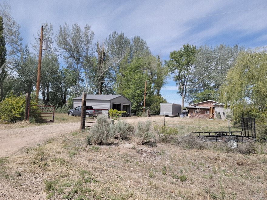 The possibilities abound with this lovely, shady, horse property. The older, but nicely updated, home was originally a 3 BR, 1 BA home, but one BR was demolished in order to make the living area larger. This could be reverted to its original floorplan, or possible converted into a primary BR.  The house is tucked back into a lot which itself is to die for, with mature trees, including fruit trees, flowering bushes, a historic cabin and plenty of large buildings which could be used for storage, a workshop or whatever. Irrigation runs right through the property! Deer, turkey and racoons are frequent visitors and the sunsets are second to none. Just north of the Merc in Randlett!Square footage figures are provided as a courtesy estimate only and were obtained from county tax records.  Buyer is advised to obtain an independent measurement. There are 13 tax parcels included in this listing. The acerage listed is the combined estimate.