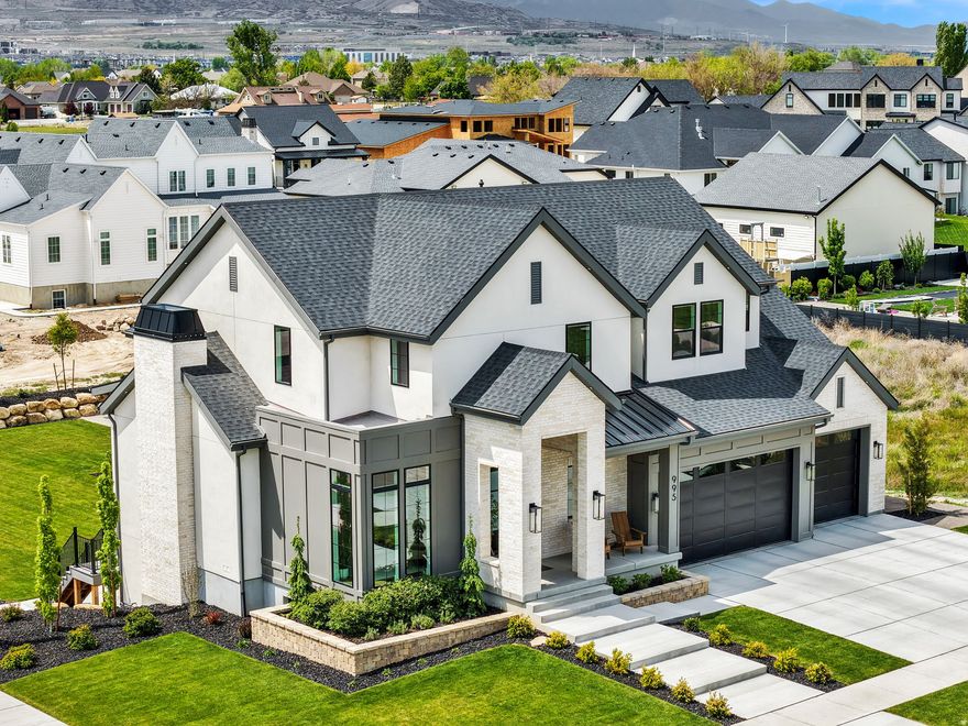 Professionally designed luxury custom home in a highly desired neighborhood, featuring a full indoor sports court/pickleball court. No matter the weather outside the indoor sports court is the perfect space for training, playing, and making year-round memories with the family. The home feels and looks brand new and is conveniently located just minutes from hiking and biking trails, restaurants, shopping, parks, schools, and quick access to I-15. It features a gorgeous open-concept floor plan, custom-designed white oak cabinets, and professionally designed, lighted landscaping on 0.41 acres. Additional highlights include a walkout basement, a full basement apartment with a private entrance and beautiful finishes, 10-foot ceilings on the main floor, and 9-foot ceilings on the second floor and in the basement. There is also a built-in reading nook in the basement, incredible mountain views from almost every part of the home, and an office with floor-to-ceiling windows. This home shows like a model, with exceptional workmanship and attention to detail throughout.