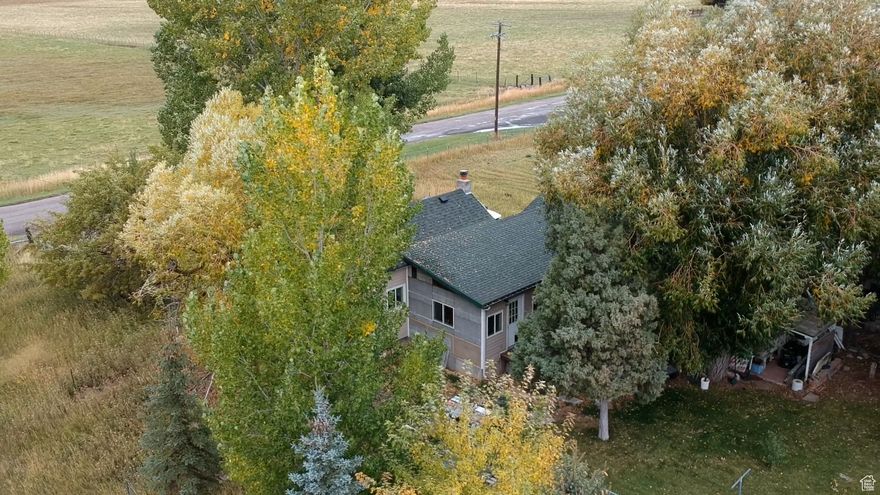 17.26-Acre Farm with Cottage & Development Potential  Near Bear Lake! Discover endless potential with this 17.26-acre property conveniently located just 20 minutes from beautiful Bear Lake. Currently planted in alfalfa and previously used for barley production, this versatile parcel combines agricultural charm with excellent commercial potential. The property includes a cozy 2-bedroom cottage, ideal as a residence, rental, or on-site manager's quarters. Numerous outbuildings, sheds, a large barn, and corrals offer abundant storage and workspace for equipment, livestock, or new ventures. Situated along Highway 30 and 8th Street, the land offers prime frontage and easy access, making it a great investment opportunity for future commercial development - perfect for Boat and RV storage, general storage, or other income-producing projects. Enjoy the best of both worlds: open country living with quick access to year-round outdoor recreation including skiing, camping, hiking, biking, and a nearby golf course. Whether you're looking to expand your farming operation, create a recreational retreat, or develop a profitable storage business, this property offers flexibility, location, and value. Key Features: 17.26 acres with productive farmland (alfalfa, formerly barley) 2-bedroom cottage, Multiple outbuildings, barn, and corrals Highway 30 & 8th Street frontage 20 minutes to Bear Lake recreation Excellent potential for RV/Boat storage or mixed-use commercial development A rare find with unlimited potential - bring your vision and make it yours!