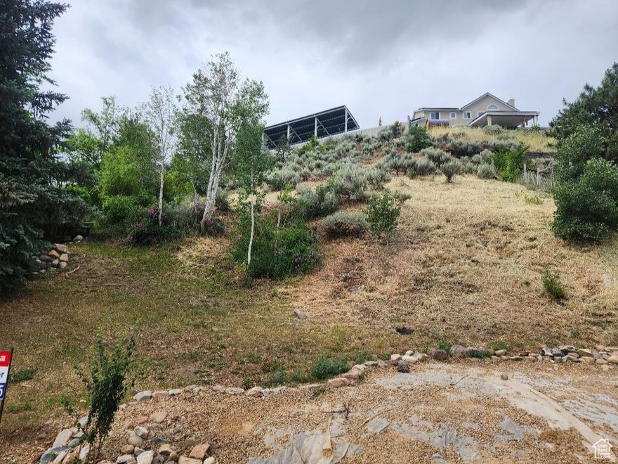 Prime .24 residential lot in quiet, beautiful neighborhood. Ideal for multi-level home with garage on bottom. Sandy City has indicated willingness to allow closer setback to road, to allow larger home footprint. Utilities stubbed to property. *Lot size from county records and is provided as a courtesy estimate only. Buyer is advised to obtain an independent measurement and to verify all info.