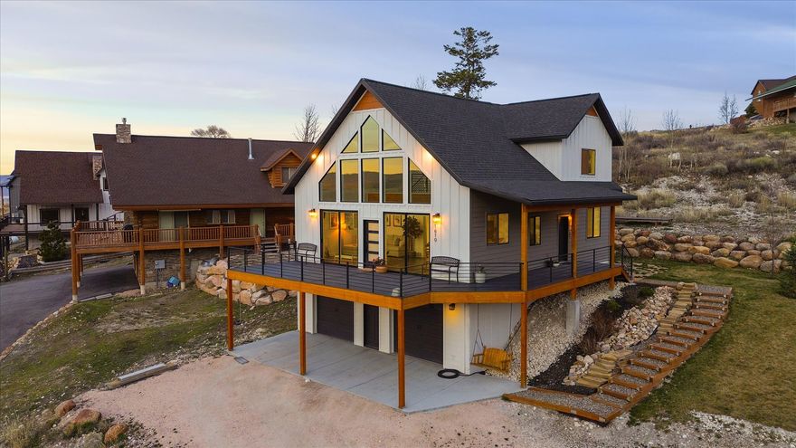 Stunning Custom Home in Gated Swan Creek Village --- Unforgettable Bear Lake Views --- Imagine waking up to breathtaking sunrises over Bear Lake from your expansive wraparound deck, or unwinding on the private balcony off the primary suite as cool evening breezes roll in. This beautifully crafted custom home sits proudly on the hill in the gated community of Swan Creek Village, just moments from the Bear Lake Marina State Park. Inside, every detail reflects true custom quality and high-end finishes. Warm natural wood beams grace the great room, creating an inviting space perfect for gathering. The stunning kitchen shines with premium Silver Falls Granite counters and a striking backsplash imported from Italy. A cozy fireplace anchors the living area-ideal for winter holiday get-togethers and making lasting memories with friends and loved ones. The flexible floor plan offers 5 bedrooms, including a standout flex room with a wet bar that can easily become a family room, home gym, or whatever suits your lifestyle. You'll also love the luxurious main-floor laundry and mudroom-perfect for hanging lake towels and gear after a day on the water. Other unique touches include a bougie sauna topping off the custom finishes found nowhere else, adding that extra layer of relaxation and exclusivity. Built to embrace the peace and beauty of Bear Lake life, this home delivers year-round enjoyment-from vibrant summer days at the marina to serene winter evenings by the fireplace. If you're looking for a true custom retreat in one of the area's most desirable gated communities, this is it. Come experience the views, the craftsmanship, and the lifestyle for yourself.