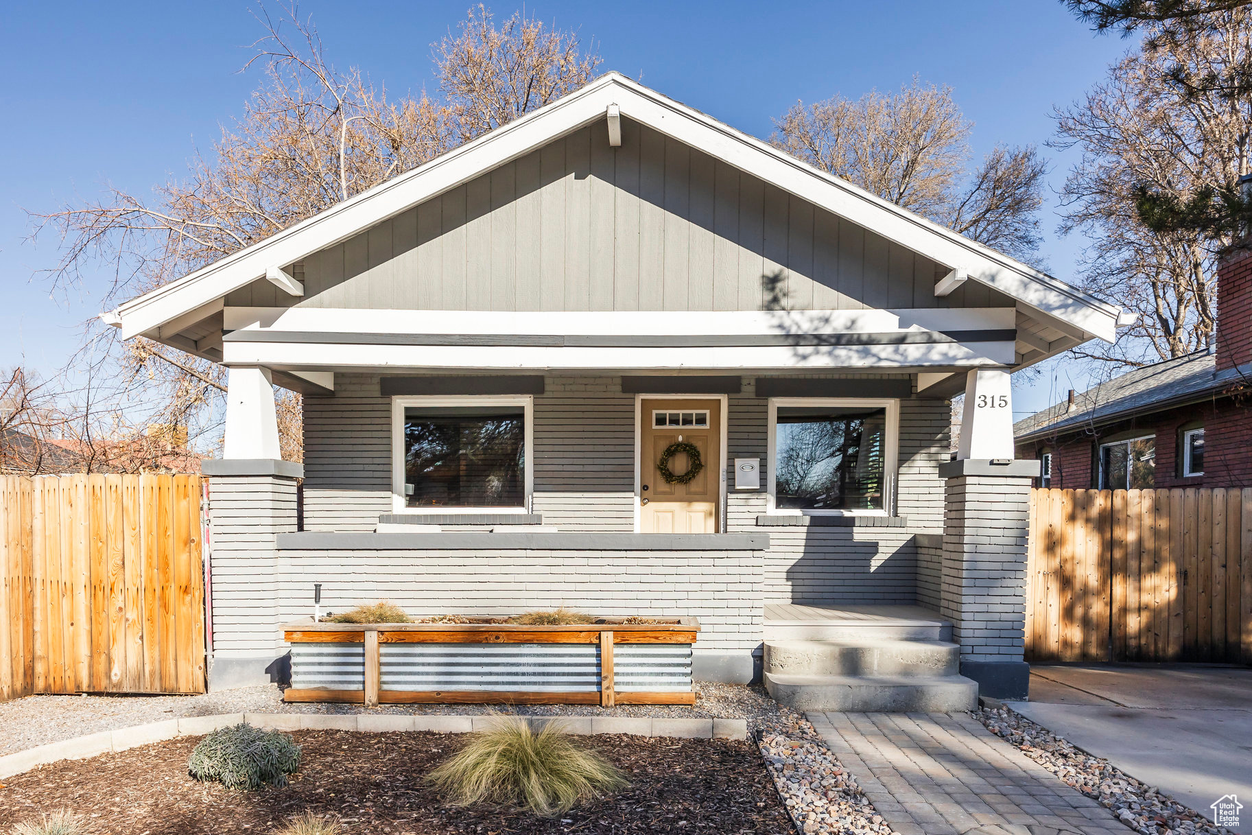 Mid-Century Modern Bungalow in the Heart of Liberty Wells. Nestled in one of Salt Lake City's most vibrant neighborhoods, this meticulously updated bungalow effortlessly combines timeless mid-century character with modern comforts. Featuring 2 bedrooms, 2 bathrooms, and a fully finished basement with its own private entrance, living area, and workspace, this home is as versatile as it is stylish.  The fresh interior and exterior paint and new carpet provide a crisp, inviting feel, while the thoughtful exterior features elevate the property's appeal. A long private driveway accommodates up to three vehicles and is secured by an electronic gate for enhanced privacy.  The backyard is beautifully designed for relaxation and entertainment, with xeriscaped landscaping, a gas fire pit complete with a built-in bench, and a putting green for refining your short game. Ideally located just five minutes from downtown Salt Lake City and thirty minutes from world-class ski resorts, this home offers unmatched convenience for work and play.  Experience the perfect blend of style, functionality, and location. Buyer and Buyer Broker to verify all info.