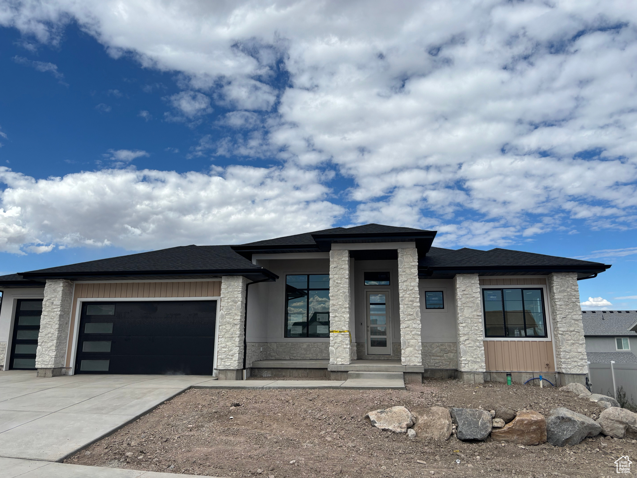 LOT#310. Estimated completion November 2025. Come see the difference from Symphony Homes, a renowned local builder of semi custom homes! Great looking rambler, the Tempo plan with our beautiful Prairie exterior, offers an ideal floor plan and magnificent views of the Wasatch from the west bench of the valley! Many upgrades throughout and classy interior design and finishes! Decorative wall in flex room off of entry, LVP floors and stunning grid bean ceiling in the family room. Galley kitchen with oversized island bar, large walk in pantry, and dining nook. Owner's suite has a recessed ceiling, garden tub, oversized shower with Euro glass and the walk-in closet is finished with custom built-ins. 2nd bedroom on main level has its own ensuite bathroom! Dedicated laundry room with a countertop. You'll love entertaining in the finished basement with family room/game room and attractive wet bar. One basement bedroom also features an ensuite bathroom, and there is a finished storage closet. Large covered deck, and lots of storage space throughout. 3rd stall of garage is 42' deep! Equipped with active radon system. Community swimming pool. Full yard landscaping is included in price and is currently in progress. Don't miss this one!