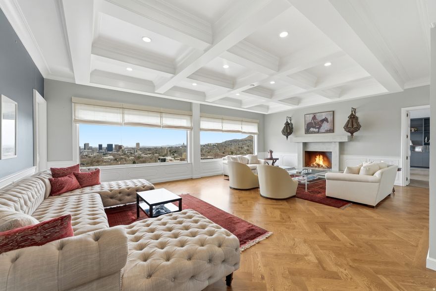 Wasatch Towers Penthouse No. 1001 commands the entire top floor of this boutique, self-managed building of only 23 residences. Step off the private elevator into 5,486 luxurious square feet, two oversized terraces, 360-degree views, and the kind of privacy that only a full-floor penthouse can offer.   The layout is thoughtful with multiple gathering areas, outdoor living space, and two fireplaces to keep things warm and grounded. The intentionally designed and well-appointed kitchen features Thermador appliances, sleek modern cabinetry, two dishwashers, and beautiful finishes. Expansive windows wrap every living space in natural light, and with the unit occupying the full floor, the views are truly panoramic- downtown Salt Lake City, the University of Utah, and the Wasatch Range filling the horizon of one of Utah's most dramatic urban backdrops. Two generous suites anchor opposite ends of the home, each with an ensuite bath and walk-in closet. A third bedroom sits tucked away for guests, the den adds flexibility, convenient laundry room, and three baths plus a powder room round out the floorplan. This residence is the only in the building with two spots in a dedicated private surface-level garage in addition to the standard spot in the communal garage.   Wasatch Towers is well-run and tight-knit, with owners who care. A new elevator was installed in 2023, the roof has been replaced, and a beautifully reimagined mid-century garden was completed in 2024. Walk to the University of Utah quad. Minutes from Research Park, Red Butte Gardens, and endless trails. Downtown Salt Lake's dining and culture is right there, and world-class skiing is just 30 minutes out.