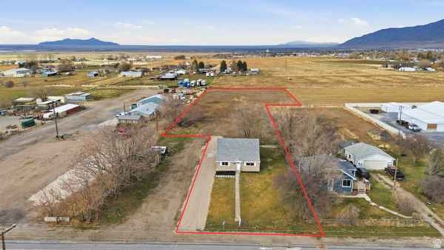 Tooele City Horse Property with high quality remodeled farm style home, and room for your new barn, corrals, and workshop! Zoned for livestock. There is a Settlement Canyon Irrigation hookup on property but, no shares go with sale. Possible to lease from Company. Great westside location with easy access.