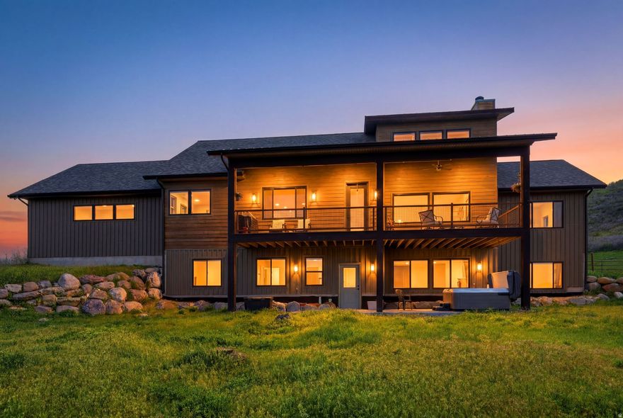 Perched on a sun-drenched hillside, 1880 Angel's Landing commands sweeping views across the Kamas Valley, with stunning panoramas of Mount Timpanogos, Deer Valley, Park City Mountain, and the surrounding Wasatch Range. Built in 2019, this thoughtfully designed 4,600-square-foot residence blends modern mountain style with refined finishes, including hardwood flooring, custom cabinetry, quartz countertops, shiplap accent walls, and premium appliances and fixtures throughout. The home's well-conceived floor plan offers effortless main-level living, featuring an open-concept kitchen and great room that seamlessly connect to the outdoors, along with a private office and luxurious primary suite. The primary bath has been recently transformed into a true spa-inspired retreat, elevating the everyday living experience. Just off the great room, a spacious covered deck creates the perfect setting for outdoor dining, entertaining, or simply relaxing while taking in the expansive mountain vistas. The walkout lower level is designed for gathering and recreation, offering a large family room, four additional bedrooms including a custom bunk room with beautifully built-in bunks. A generous patio and private hot tub provide additional outdoor living space to enjoy in every season. The kids will be outside for hours playing in the sweet treehouse. Completing the property is an oversized three-car garage with abundant room for all the equipment and toys that accompany an active mountain lifestyle. Located within the desirable Kamas East community, the property enjoys direct access to more than two million acres of National Forest land. From your doorstep, you can ride your side-by-side, ATV, or snowmobile directly onto the Hoyt Peak trail system and beyond. Offering an exceptional combination of recreation, comfort, and convenience, this home presents a rare opportunity to embrace Utah's outdoor lifestyle while remaining within easy reach of Park City and the Salt Lake Valley.