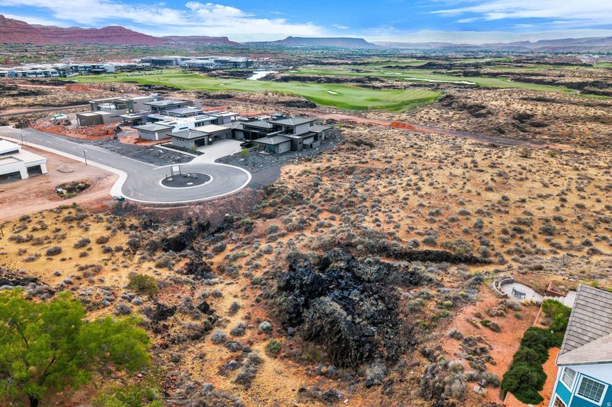 Located within the private, gated enclave of Ochre Trails at Black Desert Resort (formerly North Village), this 2.02-acre homesite is the largest and most exclusive parcels in the community. Hand-selected by a development partner, it offers a rare opportunity that cannot be duplicated. This property stands out as an exceptional value for acreage of this scale within a fully amenitized luxury resort-where opportunities like this are increasingly limited. Enjoy sweeping views of Tom Weiskopf's championship golf course, set against the iconic red cliffs of Red Mountain and Snow Canyon State Park. The size and positioning allow for a true legacy estate with privacy, scale, and seamless indoor-outdoor living. Seller is offering a sponsorship to the soon to be private golf membership which will include access to not only Black Desert Resort's premier amenities, including golf, dining, spa, fitness, pools and Waterpark, with an additional 4 courses with private club house and dining.