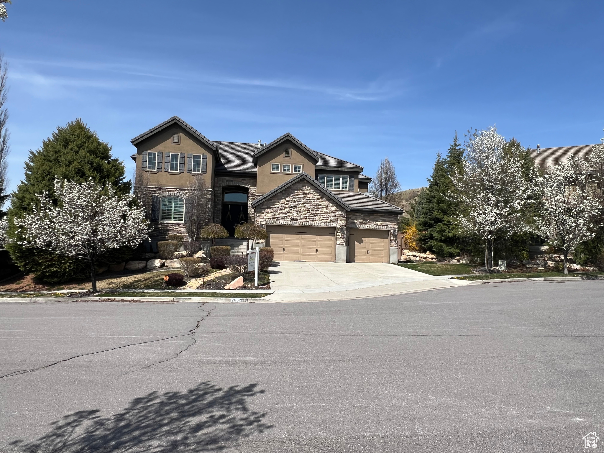 Welcome to your dream home in one of Lehi's most sought-after neighborhoods, "Woodhaven", nestled in the prestigious Traverse Mountain community area near Silicon Slopes. This beautiful 2-story home is 1 of 4 homes situated within a quiet Cul-de-sac offering mountain bench & valley views.  Once inside, beautiful, custom stained Walnut hardwood flooring throughout greets your feet. The double-height entrance foyer leads you into an open space living area adjacent to a well-appointed kitchen, complete w/ full Viking s.s. appliances, double wall ovens a large granite top island w/ weathered iron metal detailing, housing a gas countertop range, breakfast counter & custom wood, iron & frosted glass barn door concealing the pantry. The Walnut hardwood flooring continues down into the  basement which is an entertainer's delight featuring a full 2nd kitchen equally adorned w/ Viking s.s. appliances, guest room, full bathroom, home gym adjacent to a glass enclosed steam shower & a tiered floor theater room for movie nights w/ friends or family.  French door basement entrance leads you to a natural stone patio, a private hot tub, a matured landscaped, private backyard & a trellis covered deck w/ a luxury, s.s. & granite topped, luxury outdoor bbq/grill bar, ideal for outdoor activities & gatherings.  Retreat upstairs to a gorgeous primary bedroom suite w/ dual sided fireplace, a spacious "his & hers" walk-in closet, primary bath w/ dual-sink vanity, large soaking tub, luxe glass-enclosed shower & private water closet. A three-car garage provides ample storage for vehicles & outdoor gear.  Don't miss the opportunity to make this exceptional property your own!  Sq. ft. figures are provided as a courtesy estimate only. Buyer is responsible to verify all listing information & is advised to obtain an independent measurement.
