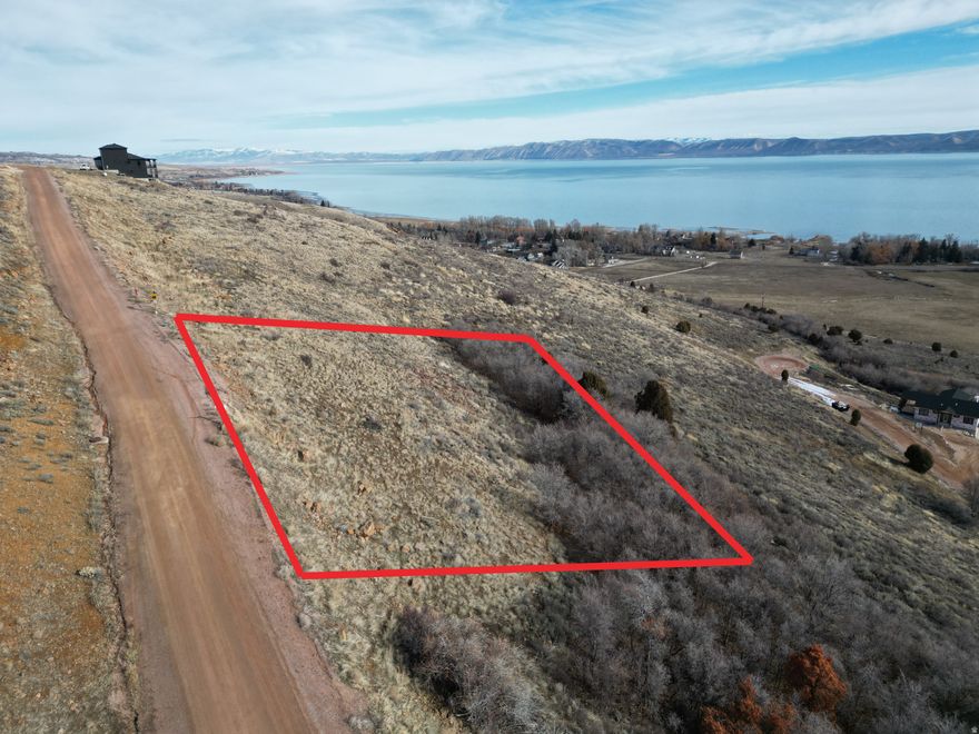 This exceptional 1-acre end lot in Swan Creek Village offers the ideal setting for a custom home with a walk-out basement, thanks to its natural slope and elevated position. The terrain not only enhances the design potential but also ensures the breathtaking Bear Lake views will remain unobstructed. Located in a private, gated community with no short-term rentals allowed, this lot provides a peaceful and exclusive atmosphere. With only one neighboring property to the north and just 3 minutes from the Garden City Marina, it perfectly balances privacy, scenery, and convenience in one of Bear Lake's most desirable neighborhoods.