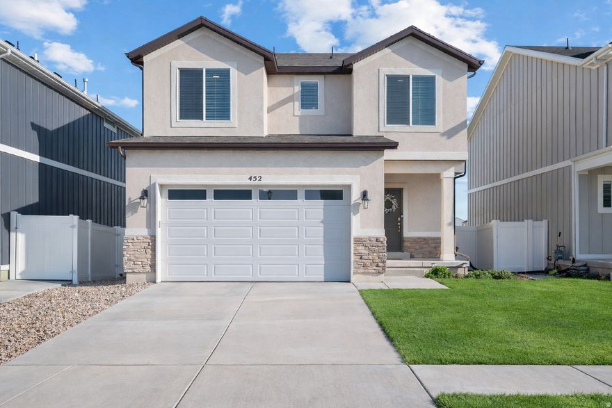 Well-designed two-story home in Saratoga Springs featuring an open floor plan ideal for everyday living and entertaining. The kitchen offers white cabinetry, a gas oven, and a large island that opens to the family and dining areas, with convenient access from the mudroom. Sliding glass doors lead to a fully fenced backyard with mountain views-perfect for relaxing or hosting. Upstairs includes a versatile loft and a spacious primary suite with a walk-in closet and private ensuite. The unfinished basement provides room to grow. Located minutes from Utah Lake, near Pioneer Crossing for easy commuting, and within walking distance to Sky Zone, The Picklr, Lehi Sports Complex, parks, shopping, and dining. Excellent location and opportunity.