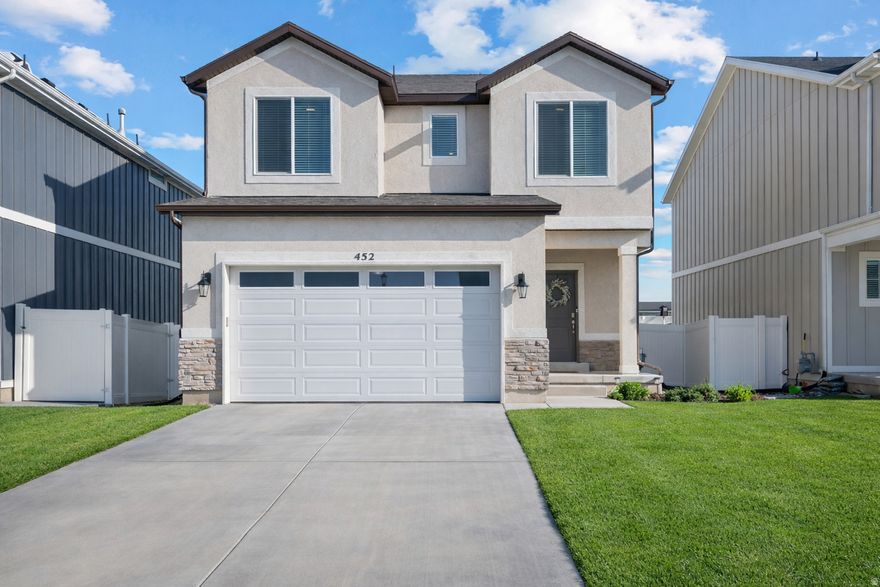 Well-designed two-story home in Saratoga Springs featuring an open floor plan ideal for everyday living and entertaining. The kitchen offers white cabinetry, a gas oven, and a large island that opens to the family and dining areas, with convenient access from the mudroom. Sliding glass doors lead to a fully fenced backyard with mountain views-perfect for relaxing or hosting. Upstairs includes a versatile loft and a spacious primary suite with a walk-in closet and private ensuite. The unfinished basement provides room to grow. Located minutes from Utah Lake, near Pioneer Crossing for easy commuting, and within walking distance to Sky Zone, The Picklr, Lehi Sports Complex, parks, shopping, and dining. Excellent location and opportunity.