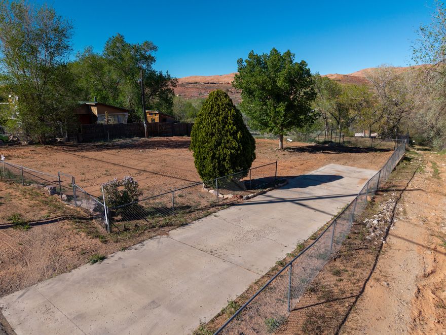 Perfect opportunity to build your home on this .22-acre lot in Spanish Valley. Tucked into a quiet setting with red rock views and open skies, this property offers privacy and accessibility. The lot is mostly fenced, and has a concrete driveway already in place, saving you time and expense as you plan your build. All utilities are stubbed to the lot. No CC&R's. Taxes are estimated.