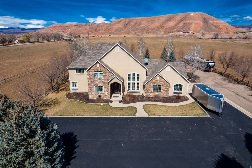 Custom-built home in Lapoint!! From the moment you step into the foyer, you're greeted by an impressive floor plan highlighted by soaring two-story vaulted ceilings and a grand staircase leading to the second level. The vaulted ceilings continue into the formal dining room, a versatile space that could also serve as an elegant formal living area. The great room is truly the heart of the home, featuring a stunning wood-burning stove with a dramatic floor-to-ceiling stone surround. This space flows seamlessly into the dining area and kitchen, which is beautifully appointed with custom cabinetry, double wall ovens, a built-in stovetop, and the rare convenience of two dishwashers. Just beyond, the great room opens to an oversized covered patio-perfect for refined outdoor living and entertaining.  This exceptional property offers 4 bedrooms, including a luxurious primary suite on the main level. The primary retreat features a spa-like bathroom with a soaking tub and an expansive walk-in shower. The laundry room is thoughtfully designed to accommodate two sets of washers and dryers, offering both function and convenience.  Upstairs, you'll find three additional bedrooms and a full bathroom, along with a spacious bonus area ideal for a second living room or private home theater. The outdoor space is equally impressive, with professionally designed landscaping, automatic drip irrigation in both the front and back, a dedicated fire pit area, and raised garden beds. Perfectly positioned in the middle of a pasture, this property offers a rare sense of privacy and wide-open views, free from neighboring sightlines. There is an additional 34 acres that is possibly available for purchase. A truly remarkable property that must be experienced to be fully appreciated.  Square footage figures are provided as a courtesy estimate. Buyer is advised to obtain an independent measurement.