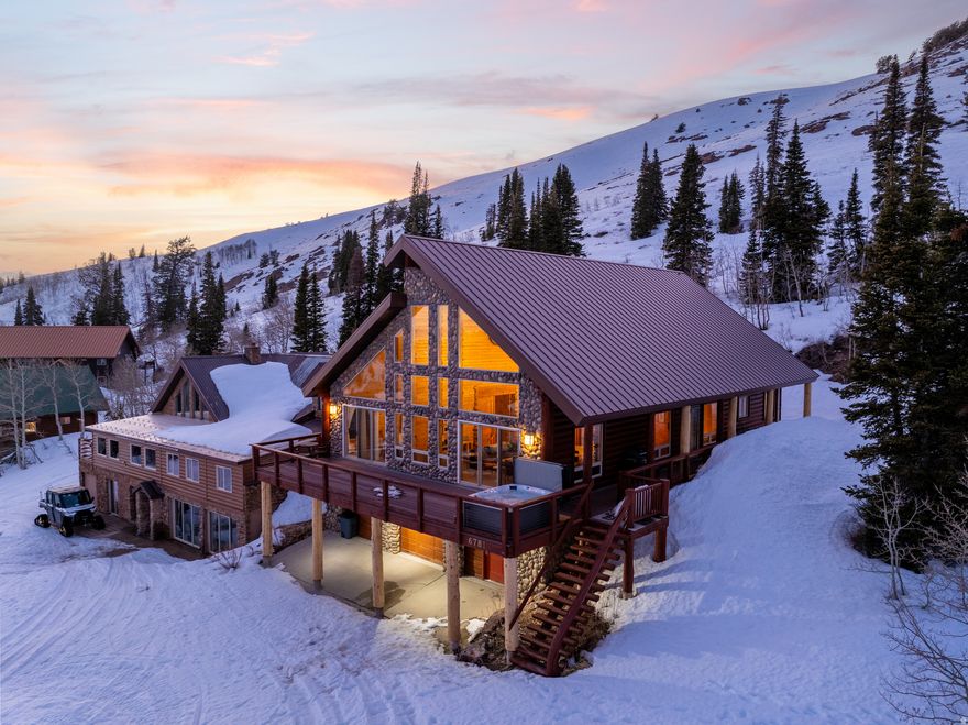 Set slopeside at Powder Mountain West, this ski-in/ski-out chalet is your front-row seat to year-round adventure. Whether you're hosting aprs-ski gatherings or escaping for a quiet mountain weekend, this home delivers the perfect blend of luxury, comfort, and unforgettable views. Tucked among towering pines, the chalet showcases dramatic architecture at every turn-soaring corrugated metal ceilings, massive timber beams, striking stonework, and walls of windows that flood the space with natural light and frame the alpine scenery. Five spacious bedroom suites offer private retreats for guests, making it ideal for entertaining groups both large and small. Zoned for short-term rentals and offered fully furnished, this turnkey getaway is ready when you are-just bring your skis in the winter, your mountain bikes in the summer, and settle into the rhythm of mountain living right outside your door. All property information, boundaries, and documents to be verified by buyer. 24-hour notice required for showings.