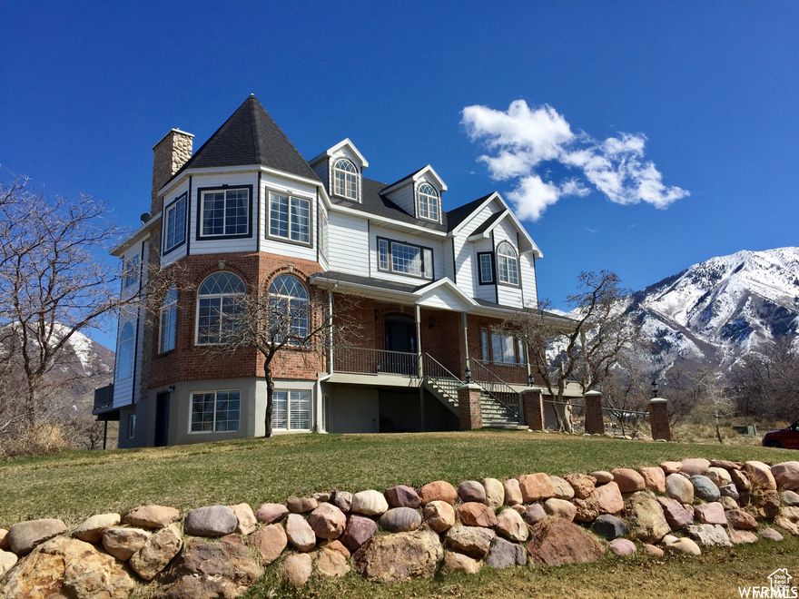 Welcome to a truly one-of-a-kind home in the heart of Salem, Utah! This stunning Victorian-inspired residence sits on a spacious .72-acre cul-de-sac lot with breathtaking mountain and valley views. With over 4,700 square feet of living space across four levels, this home is bursting with charm, character, and flexible living options. From the moment you step inside, you'll be drawn to the grand foyer, arched entryways, and sun-filled step-down living room featuring a fireplace and expansive windows. The open kitchen and dining area are perfect for gathering, and the layout includes a main-level office, three laundry rooms, and even a tower bonus room on the top floor-ideal as a creative studio or private retreat. The luxurious primary suite features bay windows, a fireplace, dual walk-in closets, and an open-concept bath with incredible natural light. Downstairs, a separate-entry basement apartment provides a second kitchen and private space for multigenerational living, guests, or potential rental income. Additional highlights include a 3-car garage, covered porch, massive back deck, and ample parking with a circular drive. No HOA, incredible views, and unique features throughout-this is not your average home. Come experience all it has to offer today!
