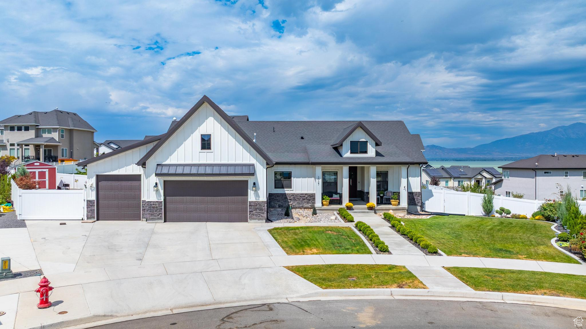 Cul-de-Sac lot big enough for a pool or pickle ball. With breathtaking lake and mountain views, this exquisite modern farmhouse offers 4,746 square feet of luxury on 1/3 acre. Designed for both elegance and comfort, this home features impeccable craftsmanship, upscale finishes, and a thoughtful layout that maximizes both style and functionality. The gourmet kitchen is a chef's dream, featuring double ovens, a gas stovetop, a quartz island with a green shiplap base, stainless steel appliances, and wood shaker cabinets that extend to the ceiling. It has 2 pantries, including a massive 4' x 22' pantry that provides incredible storage, and the home includes the refrigerator in the kitchen. Vaulted ceilings in the great room and primary suite create an open and airy ambiance, while Italian tile flooring throughout the main level and basement adds a touch of sophistication. Plush carpeting in the bedrooms ensures warmth and comfort, and the basement boasts 9' ceilings, double vanities in the bathrooms, cold storage, and an abundance of additional storage throughout. A water softener and reverse osmosis system enhance the home's convenience and efficiency. The fully fenced and landscaped yard is designed for both beauty and functionality, featuring a gazebo for outdoor dining, firepit, vegetable garden, fruit trees (apple, peach), RV Parking, PLUS a Shed with power for extra storage or your gardening delights. Close to several parks and Pelican Bay Marina **With Preferred Lender, Buyer to receive 1/0 buydown.** ***The pool shown is a digital rendering, included to spark inspiration and show backyard potential. This home does not currently have a pool. Any future installation would be at the buyer's expense and subject to city/county permitting and approval.***