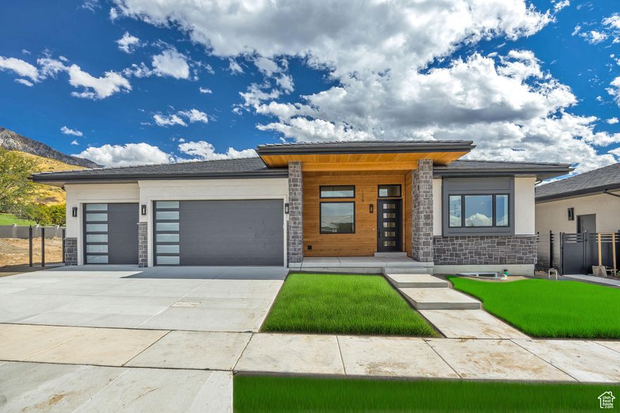 Move-in ready and newly priced at $1,375,000-this is your chance to step into NE Orem's Abbey Road lifestyle with built-in value: the home recently appraised at $1,430,000. Crafted by Whitehaven Builders, this modern prairie masterpiece pairs refined design with real-life function across 5,400+ finished sq. ft.-made for effortless entertaining, cozy nights in, and everything in between.  From the moment you enter, the main-level great room steals the show with 13' vaulted ceilings, a striking gas fireplace, and expansive panoramic doors that open to an east-facing patio with mountain views. The chef's kitchen is equally unforgettable-anchored by a massive quartz island, Fisher & Paykel appliances, and a hidden walk-in pantry that feels like a second kitchen (complete with 2nd sink, dishwasher, and custom storage).  Retreat to the main-floor primary suite, where a spa-inspired bath with an oversized double shower and a custom walk-in closet (with washer/dryer hookups) turns daily routines into a luxury. Downstairs, the fun continues: a sprawling family room with kitchenette, a dedicated children's play nook, a private theater with tiered seating, and a sleek glass-enclosed gym. Ensuite bedrooms offer privacy and comfort for family and guests alike.  Every detail is dialed in-smart, energy-efficient systems, dual furnaces, instant hot water, LED lighting, and a fully finished 3-car garage with epoxy floors, hot/cold water, and EV outlet. Outside, enjoy the longevity and curb appeal of a 75-year Bar-Tile roof with low-maintenance stone, stucco, and cedar. The landscaped, fenced yard and nearby Murdock Trail make it easy to live active, while Abbey Road HOA perks-pickleball court, lawn care, and snow removal-keep weekends open for fun.  You're minutes to Harmons, University Place, Provo Canyon, and I-15, putting shopping, dining, and outdoor adventure right at your doorstep.  Incentive: With a full-price offer, Whitehaven Builders is offering up to $10,000 toward buyer-selected customizations (cabinetry, appliances, fixtures, water softener, or surface protection), plus a 1-year builder warranty and applicable manufacturer equipment/appliance warranties. Special Financing Available: Seller finance or lease-to-own options with 20% down, 6.99% interest, 30-year amortization, and a 23 year balloon-ask for details and terms.
