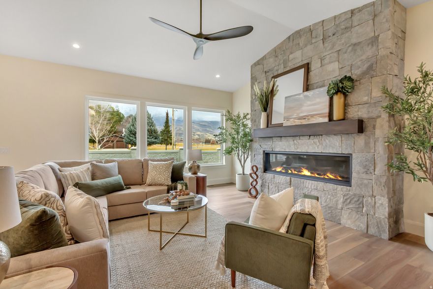 Just Reduced!  Open house Friday 2/20 4-7 pm and Saturday 2/21 11am to 2 pm.  Beautifully finished and ready now-this is your opportunity to step into NE Orem's coveted Abbey Road lifestyle with built-in value. The home recently appraised at $1,430,000 and is crafted by Whitehaven Builders, pairing refined modern prairie design with real-life function across 5,400+ finished sq. ft.-made for effortless entertaining, cozy nights in, and everything in between. From the moment you enter, the main-level great room steals the show with 13' vaulted ceilings, a striking gas fireplace, and expansive panoramic doors that open to an east-facing patio with mountain views. The chef's kitchen is equally unforgettable-anchored by a massive quartz island, Fisher & Paykel appliances, and a hidden walk-in pantry that feels like a second kitchen (complete with a second sink, dishwasher, and custom storage). Retreat to the main-floor primary suite, where a spa-inspired bath with an oversized double shower and a custom walk-in closet (with washer/dryer hookups) turns daily routines into luxury. Downstairs, the fun continues: a sprawling family room with kitchenette, a dedicated children's play nook, a private theater with tiered seating, and a sleek glass-enclosed gym. Ensuite bedrooms offer privacy and comfort for family and guests alike. Every detail is dialed in: smart, energy-efficient systems, dual furnaces, instant hot water, LED lighting, and a fully finished 3-car garage with epoxy floors, hot/cold water, and an EV outlet. Outside, enjoy the longevity and curb appeal of a 75-year Bar-Tile roof with low-maintenance stone, stucco, and cedar. The landscaped, fenced yard and nearby Murdock Trail make it easy to live active-while Abbey Road HOA perks like pickleball, lawn care, and snow removal keep weekends open for fun. You're minutes to Harmons, University Place, Provo Canyon, and I-15, putting shopping, dining, and outdoor adventure right at your doorstep. Special Financing Available: Seller financing and/or lease-to-own options may be available-ask for terms and details.