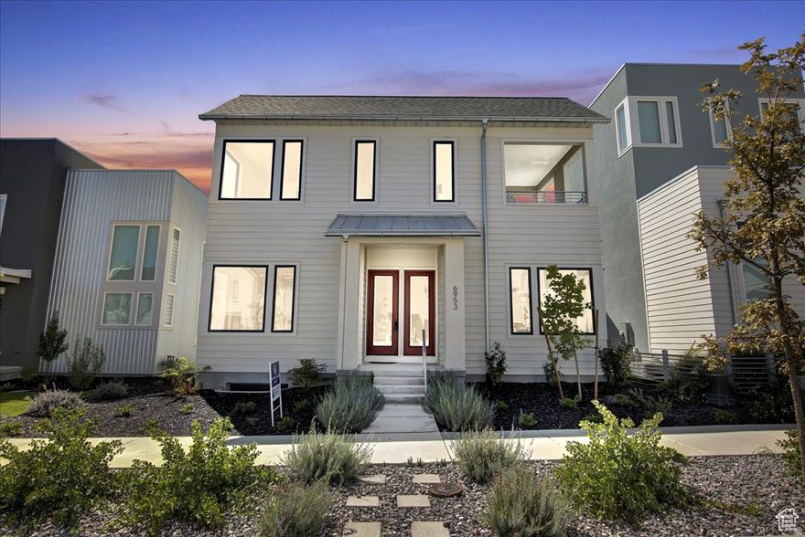 This award-winning home combines modern luxury with thoughtful design. Just moments from Daybreak's highly anticipated Watercourse. Bright and open, the main living area is filled with natural light and features expansive sliding glass doors that extend your living space onto a spacious patio-perfect for everything from quiet mornings to lively gatherings. The chef's kitchen flows seamlessly into the living room, creating a warm and inviting atmosphere for entertaining.  Highlights include a butler's pantry, top-of-the-line appliances and built-in bookshelves that add both style and function. Located with walking distance of outdoor recreation, including paddleboarding at the Watercourse, Lookout Park and local favorites like Swig.