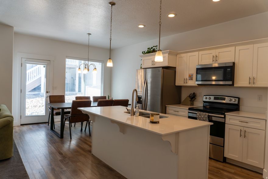 Welcome to this upgraded Herriman townhome in the Sky Ridge community. Built in 2018, this home offers 4 bedrooms, 3 bathrooms, and over 2,200 square feet of living space with a finished daylight basement. The main living area features vaulted ceilings that create a bright and spacious feel. The kitchen has white shaker cabinets, quartz countertops, and brushed nickel finishes throughout. The layout flows easily from the living room to the kitchen and dining area, making it ideal for everyday living or hosting friends and family. The finished basement adds valuable extra space. It includes a large family, a full bathroom, a fourth bedroom, and multiple storage areas, including under-stair storage and a finished pantry space. Residents in Sky Ridge enjoy access to a clubhouse, gym, swimming pool, parks, playgrounds, and miles of nearby biking and hiking trails. The location offers quick access to Mountain View Village shopping, restaurants, Daybreak amenities, and the new Salt Lake Bees stadium. Buyer to verify all info.