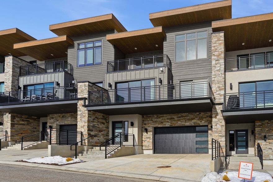 Enjoy sweeping panoramic views of the lake, mountains, and Deer Valley Resort  East Village from this beautifully appointed, fully furnished townhome at Klaim. Thoughtfully designed in a modern contemporary style, the residence showcases custom cabinetry, hardwood flooring, and quartz countertops throughout. Soaring ceilings-especially on the top level-create a bright, open atmosphere enhanced by expansive window packages that frame the surrounding scenery and flood the home with natural light. A dramatic three-panel sliding glass wall seamlessly blends indoor and outdoor living, bringing the views directly into the main living space.  The upper level features a secondary living area, ideal for relaxing, entertaining, or enjoying private time away from the main gathering spaces. The second level offers two additional bedrooms connected by a well-designed Jack-and-Jill bath, providing both comfort and functionality for family and guests.  Perfectly positioned at the top of the development and backing to 40 acres of dedicated open space, this property offers exceptional privacy and tranquility. The rear patio is perfectly suited for a hot tub, complemented by a convenient wet bar that enhances entertaining opportunities-whether indoors, on the patio, or from the upper balcony.  Ideally located just 15 minutes from Deer Valley Resort  East Village and minutes from Jordanelle Reservoir, you'll enjoy effortless access to boating, paddleboarding, hiking, biking, equestrian trails, and golf. Nightly rentals are permitted, offering excellent flexibility as a primary residence, vacation retreat, or investment property. Snow removal and landscape maintenance are included, creating a true lock-and-leave lifestyle opportunity.