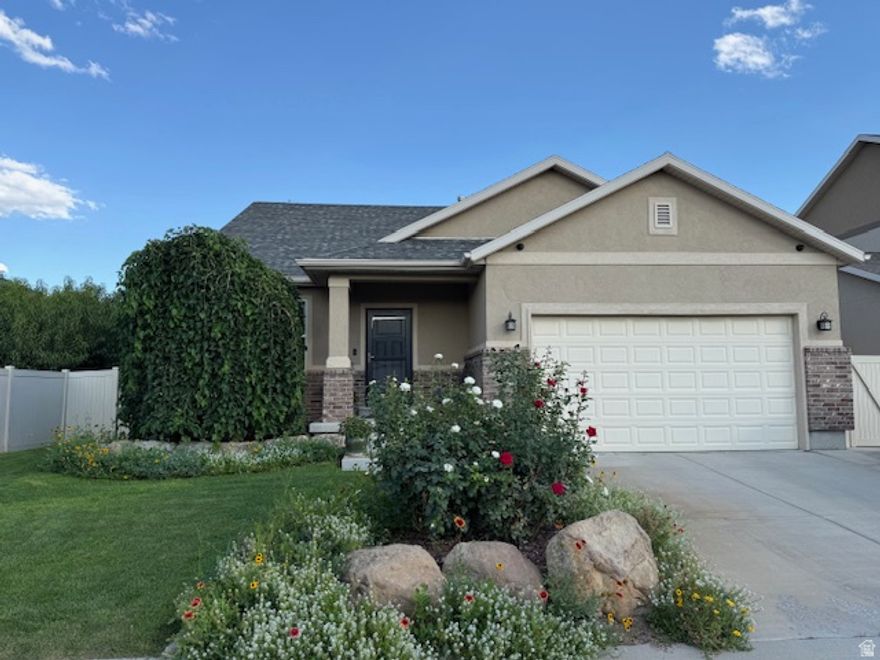 This immaculate original owner rambler in the highly desirable Thanksgiving Meadows community offers beautiful natural light and comfortable main level living in one of Lehi's most convenient locations. Featuring over 3,200 square feet with 5 bedrooms and 3 bathrooms, the home includes a fully finished basement with a second kitchen, creating excellent space for multi generational living or potential rental opportunities. An exterior entrance could also be added on the west side of the home if a future owner wanted to create a more private basement setup. The main level features hardwood floors, granite countertops, plantation shutters, and an open layout perfect for everyday living and entertaining. The fully landscaped yard with mature trees provides a peaceful outdoor setting while the HOA offers fantastic amenities including a pool, clubhouse, gym, playground, and walking trails. Ideally located just minutes from Thanksgiving Point, Traverse Mountain, Silicon Slopes, and quick freeway access, this home offers incredible convenience to shopping, dining, and many of Utah's major tech companies.