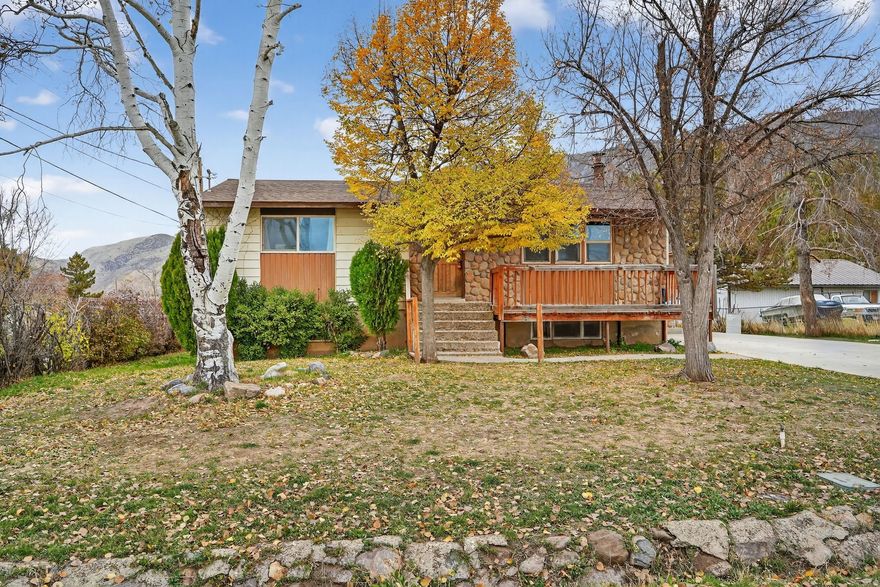 Charming Santaquin rambler on a rare in-town horse property with a large 0.29 acre lot. This 5 bedroom, 2 bathroom home offers approx. 2,208 sq ft of living space with a comfortable layout and plenty of room to grow. Enjoy a mature, fully landscaped yard with shade trees, partial fencing, and space for animals or a garden. Inside you'll find a cozy wood stove, included range, and convenient electric dryer hook-up. Located close to schools, parks, and city amenities while still offering an agricultural feel. Buyer to verify all information, including square footage and acreage, to buyer's satisfaction.