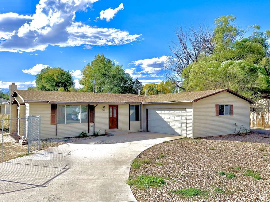 Welcome to your new home! This charming 3-bedroom, 2-bath rambler with a master suite sits on a spacious corner lot with a full chain-link fence on a quiet street. The large, open living room offers plenty of space for a home office or formal dining area and features a comfortable, flowing floor plan. Recent updates include fresh paint and new carpet, making this home truly move-in ready. Enjoy the convenience of stainless steel appliances in the kitchen. The attached 2-car garage and extra parking provide ample room for vehicles, RVs, or other toys. Don't wait-this one will go fast!
