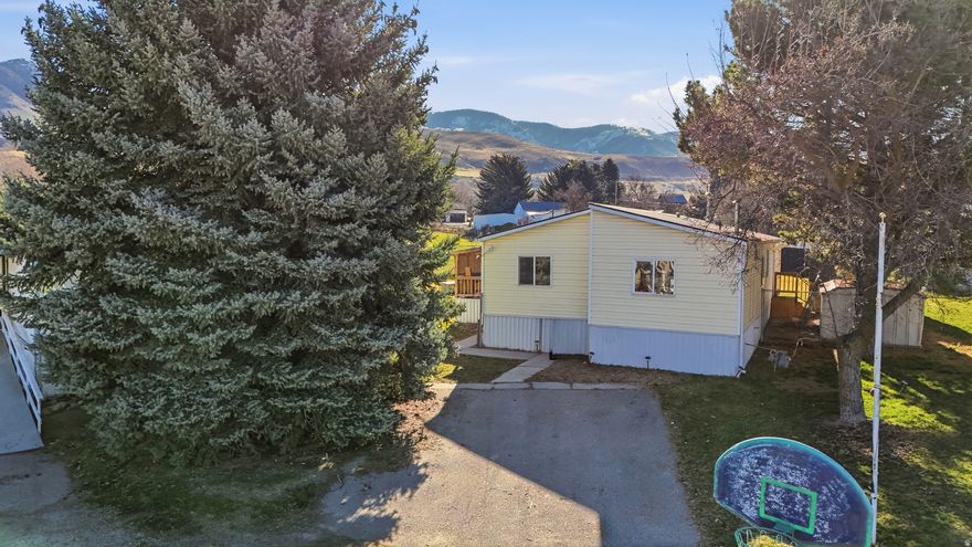 Renovated double-wide manufactured home with a spacious backyard, front porch, and mountain views. Features updated plumbing lines, new electrical boxes, outlets, and switches, along with new carpet, LVP flooring, skirting, paint, countertops, and more. Conveniently located just 5 minutes from Richmond Square, grocery stores, schools, and other amenities. Appliances and two sheds are included. Square footage is provided as a courtesy estimate from the title; buyer to verify independently. Agent can recommend lenders.