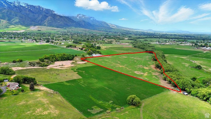 Rare opportunity to own 35 acres with direct Bear River frontage, panoramic views of the Wellsville Mountains, and endless potential. This private, serene property offers a mix of open land and mature trees, perfect for building your dream home, recreational use, or development. Enjoy fishing, farming, and wildlife watching right from your own land. Convenient location with easy access to town. A true slice of paradise with investment potential. Includes 2 parcels (10-010-0010 & 10-017-0006) 15 Water shares in the Mendon-Wellsville Canal and water rights from other sources. Click tour button for video tour of the property.