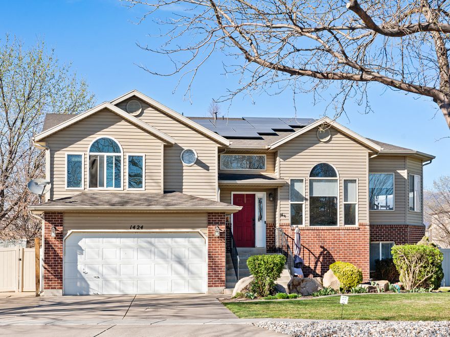 Welcome to this spacious, beautifully updated home in a desirable Woods Cross neighborhood, offering the perfect blend of comfort, style, and functionality. Situated on a generous 0.22-acre lot, this impressive residence boasts 3,182 square feet of living space, featuring 6 bedrooms and 3 bathrooms-ideal for growing households or those who love to entertain.  Step inside to a thoughtfully designed layout filled with abundant natural light from double-pane windows and sliding glass doors. The newly renovated kitchen is a true highlight, showcasing stainless steel appliances-including an oven, refrigerator, and dishwasher-along with a cozy breakfast nook perfect for everyday dining. The primary suite provides a private retreat, complete with a beautifully updated bathroom and a spacious walk-in closet.  Both upper and lower living areas offer flexible space for gatherings, a home office, or guest accommodations.Outdoors, enjoy the open porch, ambient lighting, and a tranquil water feature that enhances the backyard setting-perfect for relaxing evenings or weekend entertaining. Additional features include a 2-car garage and energy-efficient solar panels for added savings. Blending modern updates with generous space and timeless appeal, this home is a standout in a sought-after location-don't miss your opportunity to make it yours!