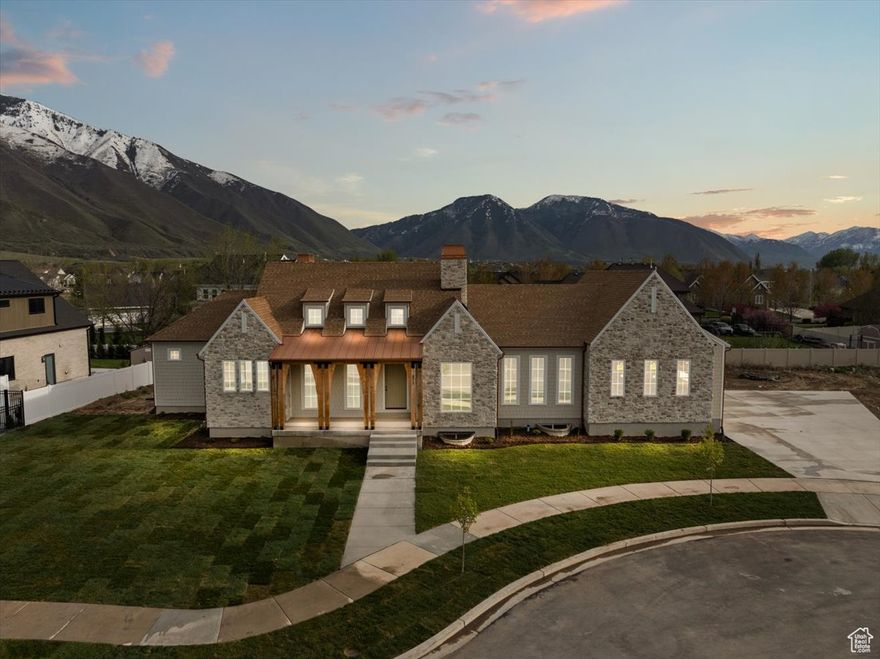 Welcome to the Earth house, a custom sanctuary in the heart of Mapleton! Designed with rich, organic earth tones and warm finishes that blend seamlessly into the surrounding landscape, this home offers the ultimate retreat with luxurious finishes at every turn.  The walk-out basement has a designated gym/sauna area perfect for your daily reset, and there's ample space to add a full movie theater. Oversized windows throughout frame breathtaking mountain views, while thoughtful architecture brings natural light into every room.  This home sits in a private cul-de-sac and perfectly balances design and functionality in all the right ways.  Ready to make the mountains your backdrop?