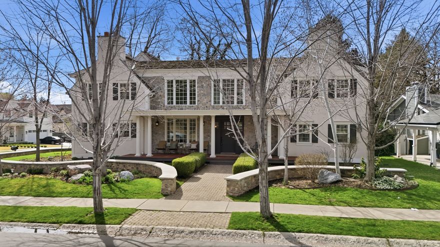 Exceptional New Englandinspired farmhouse style home located in one of Holladay's most sought-after neighborhoods. Rebuilt in approx. 2011with remarkable quality and craftsmanship, this 5-bedroom, 5-bath residence seamlessly blends timeless architectural charm with refined modern living. From the moment you arrive, the home's striking curb appeal makes a lasting impression-featuring a welcoming mahogany-covered front porch, classic stone, stucco, shake shingle roof and beautifully curated landscaping with a winding stone wall and lush gardens. Inside, a bright, airy interior unfolds with soaring ceilings, rich walnut hardwood floors, and exquisite millwork that adds warmth and sophistication throughout. Designed for both everyday comfort and elegant entertaining, the open-concept floor plan offers a perfect balance of formal and casual living spaces. A dramatic double-height great room with a lovely fireplace creates a central gathering space, while architectural columns and custom built-ins add depth and character. The gourmet kitchen features designer cabinetry, high-end stainless-steel appliances, a professional-grade range, and striking Carrara marble countertops. The luxurious primary suite serves as a private retreat, complete with vaulted ceilings, custom built-ins, and its own fireplace. The spa-like ensuite bath offers dual marble vanities, a soaking tub, and a spacious custom dressing room. Four of the five bedrooms include en-suite baths, providing comfort and privacy for family and guests alike. Additional highlights include a lofted sitting area, multiple laundry spaces, fully finished lower level with an inviting recreation room and built-ins, two car garage with extra high ceilings and storage, mud room with cabinet lockers, and a private backyard with a deck and stone patio. Every detail of this home reflects thoughtful design and superior craftsmanship. Combining classic farmhouse elegance with modern functionality, this extraordinary Holladay property offers a rare opportunity to own a truly timeless home in a premier location. Sq ft per recent measurement by a Licensed Certified Appraiser & is only provided as a courtesy, Buyer to verify all pertinent information.  BR on main is currently being used as an office/family room but could be used as a main floor Primary Suite with its own full bath.