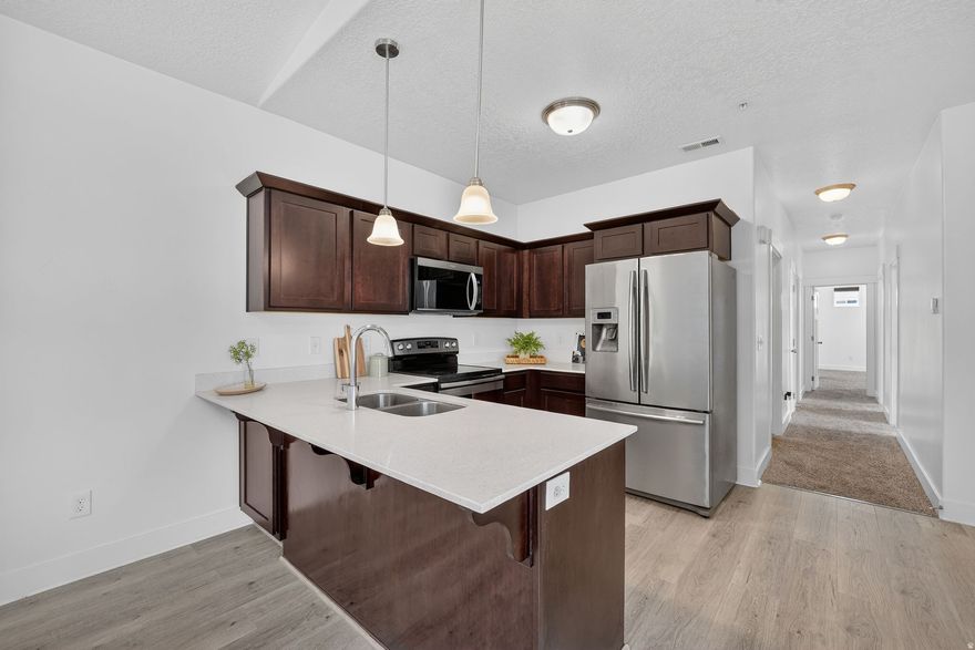 Seller Financing Available on this lovely third-level unit located in the Quailhill community! This 3rd floor condo  features quartz countertops in the kitchen, new flooring, vaulted ceilings, a walk-in closet in the master, a man door to the garage from the breezeway, and is located just 10 minutes away from Costco, Smiths, FatCats and multiple parks! The community includes amenities such as playgrounds, a swimming pool, a dog park and a clubhouse with a gym. Come see it before it's gone! Washer, Dryer, and Fridge are included in the sale!   Square footage figures are provided as a courtesy estimate only and were obtained from county records .  Buyer is advised to obtain an independent measurement.